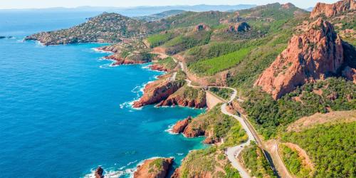 a road on the side of a mountain next to the ocean at Loup Castel Boutique Hotel B&B in Le Bar-sur-Loup