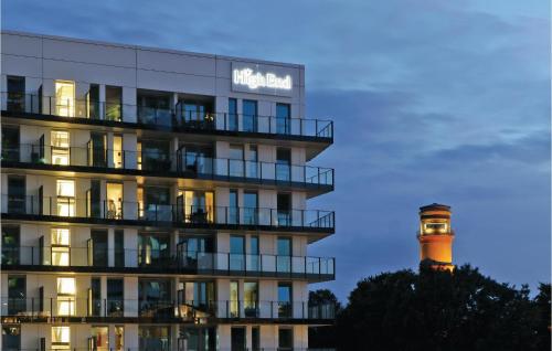 a hotel with a lighthouse in front of a building at Highend Travemünde - Whg 09 in Travemünde