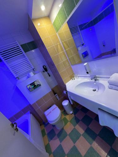 a bathroom with a sink and a toilet at Athina Airport Hotel in Thérmi