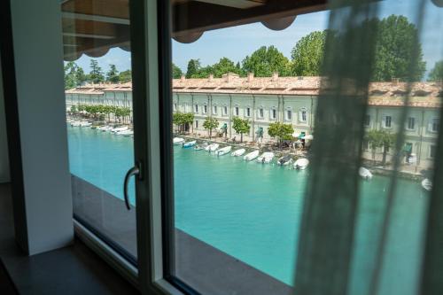 a view of a river from a window at C House Rooms Lake in Peschiera del Garda