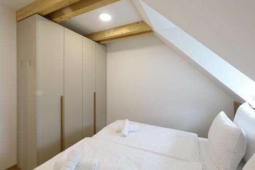 a bedroom with a white bed with white pillows at Alpine Haven in Bovec