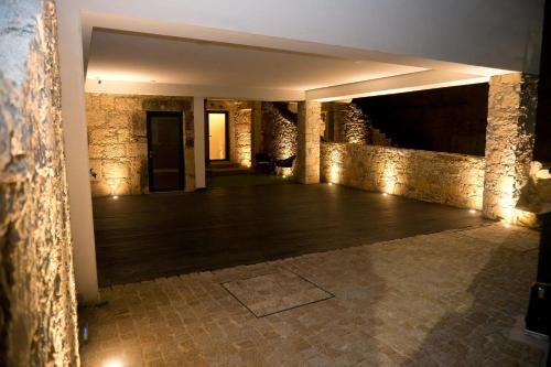 a large room with a wooden floor and stone walls at Casa 81 in Soito