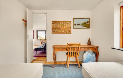 a bedroom with a desk with a chair and a bed at Cozy Home In Slagelse With Wifi in Slagelse