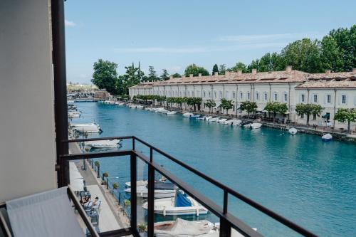 a view from a balcony of a river with boats at C House Rooms Lake in Peschiera del Garda