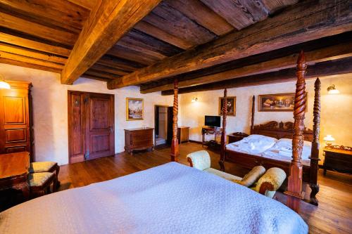 a bedroom with a bed and a wooden ceiling at Penzion Baroko in Český Krumlov