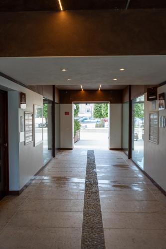 an empty hallway of a building with a walk way at C House Rooms Lake in Peschiera del Garda