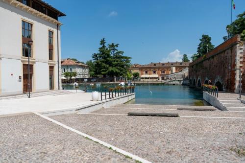 a pool of water in the middle of a building at C House Rooms Lake in Peschiera del Garda