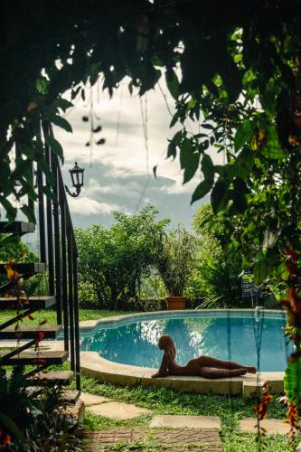 a woman laying in a swimming pool at Hotel Juayua in Juayúa