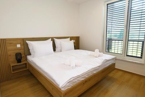 a bedroom with a large bed with two white pillows at Alpine Haven in Bovec