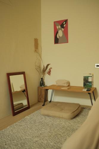 a room with a table and a mirror and a rug at Maru in Tainan
