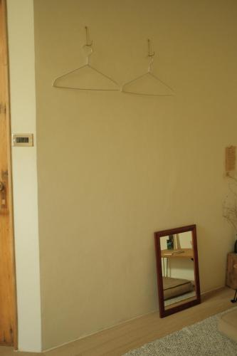 a mirror on a wall next to a room at Maru in Tainan