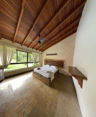 a bedroom with a bed and a wooden ceiling at Casa Fuego in La Pintada