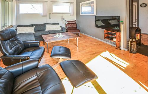 a living room with a couch and a table at Two-Bedroom Holiday Home Broager With A Fireplace 07 in Broager