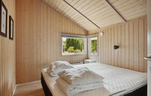 a bedroom with a bed with white sheets and a window at Lovely Home In Skælskør With Wifi in Skælskør