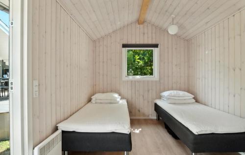 two beds in a room with a window at Lovely Home In Skælskør With Wifi in Skælskør