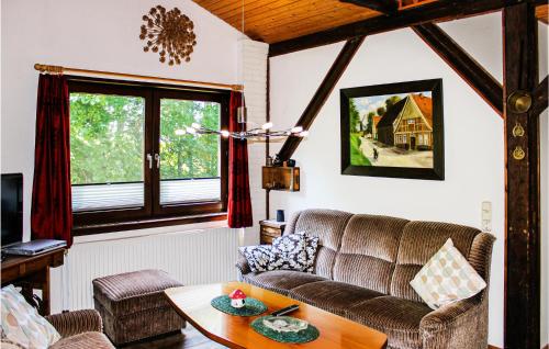 a living room with a couch and a table at 2 Bedroom Cozy Apartment In Otterndorf in Otterndorf