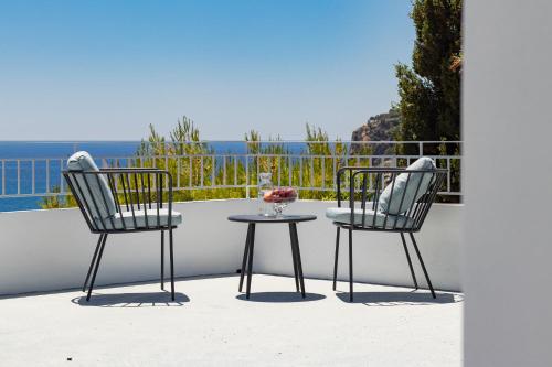 two chairs and a table on a patio at Villas Maher Two in Vasilítsion