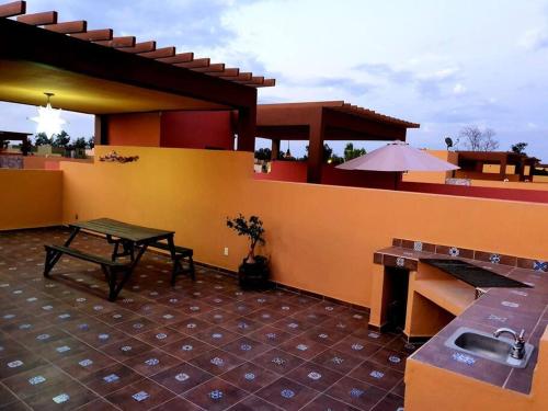a patio of a house with a table and a sink at Departamento Casa Oaxaca SMA Pool Rooftgarden in San Miguel de Allende