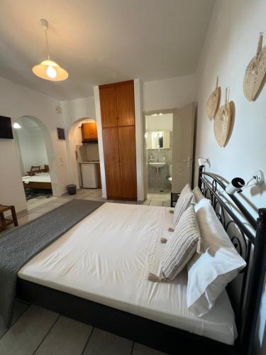 a bedroom with a large white bed in a room at Vino suites in Agia Anna Naxos