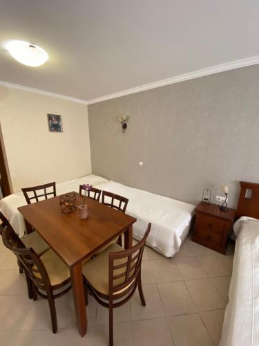 a room with a dining table and two beds at Sozopol Santa Marina Sea View Studio in Sozopol