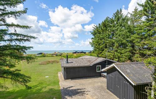 a home with a black shed and trees at Beautiful Home In Spøttrup With Kitchen in Spottrup