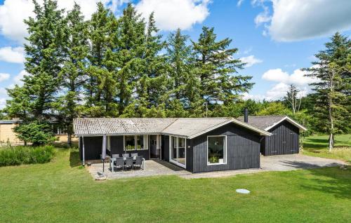 a black house with a gambrel roof at Beautiful Home In Spøttrup With Kitchen in Spottrup