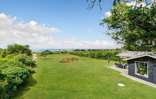 a yard with a small house and a building at Beautiful Home In Spøttrup With Kitchen in Spottrup
