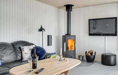 a living room with a couch and a wood stove at Beautiful Home In Spøttrup With Kitchen in Spottrup