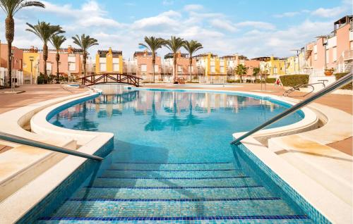 a swimming pool in a city with palm trees and buildings at Charming Apartment With Pool in Vera