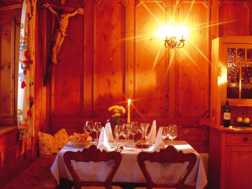 a table with a white table cloth and wine glasses at Landgasthof Jagerwirt in Volders