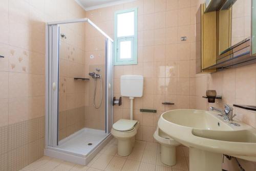 a bathroom with a shower and a toilet and a sink at Casa Tonio by BarbarHouse in Taviano