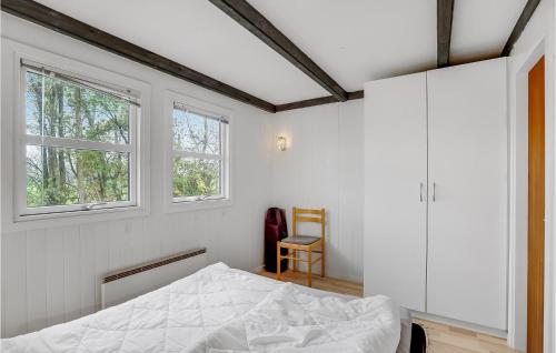 a bedroom with a bed and two windows at Cozy Home In Vinderup With Kitchen in Vinderup