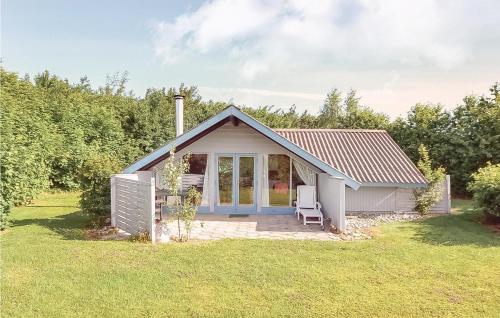 a small house with a patio in a field at Two-Bedroom Holiday Home In Sydals in Skovbyballe
