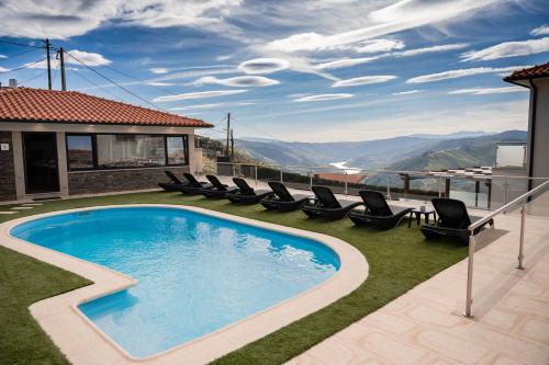 a swimming pool on the roof of a house at Socalcos do Douro House in Valença do Douro