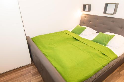 a bed with a white comforter and pillows at CheckVienna - Diefenbachgasse in Vienna