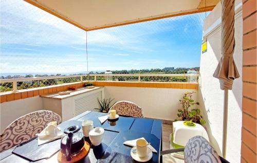 a balcony with a table and chairs and a view at Cozy Apartment In Cabanes With Wifi in Cabanes