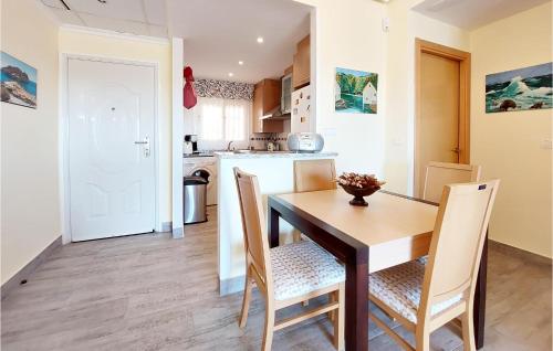 a kitchen with a dining room table and chairs at Cozy Apartment In Cabanes With Wifi in Cabanes