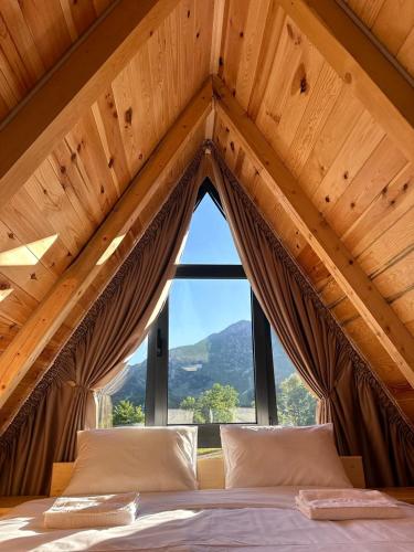 a bedroom with a bed with a large window at Monte zone in Žabljak