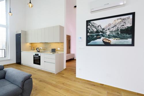 a living room with a couch and a kitchen at Alpine Haven in Bovec