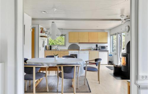 a kitchen and dining room with a table and chairs at Three-Bedroom Holiday Home In Vig in Vig