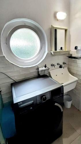 a bathroom with a sink and a mirror at Dom nad morzem in Pobierowo