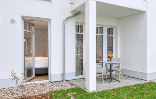 a sliding glass door leading to a patio with a table at Baltischer Hof Apartment 20 in Boltenhagen
