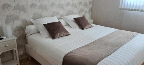 un lit avec deux oreillers dessus dans une chambre dans l'établissement T2 dans une jolie résidence arborée de FRÉJUS, à Fréjus