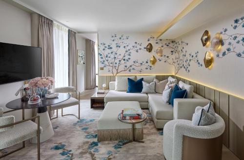 a living room with a couch and a tv at Mandarin Oriental Mayfair, London in London