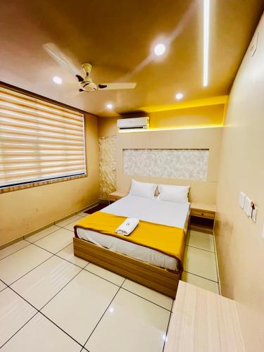 a bedroom with a bed and a ceiling fan at Famstay and healthclub in Kannur