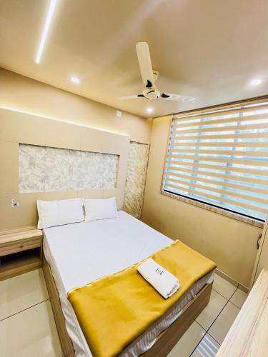 a bedroom with a bed and a window at Famstay and healthclub in Kannur