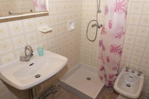 une salle de bain avec un lavabo, des toilettes et une douche dans l'établissement Gîte Location 3/4 pers à Grandviala, à La Chaze-de-Peyre