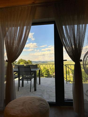 a bedroom with a view of a balcony with a table at Monte zone in Žabljak