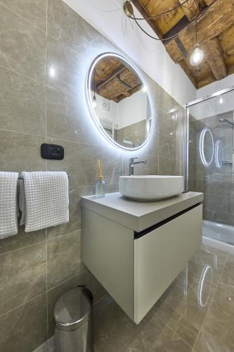 a bathroom with a sink and a mirror at SARPI Apartment & Suite in Udine