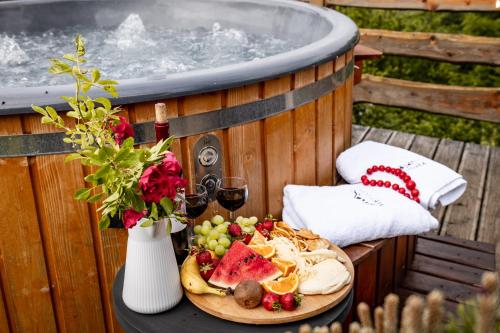 a table with a plate of food and a bowl of fruit at HRYCÓWKA Domki z Widokiem in Grywałd